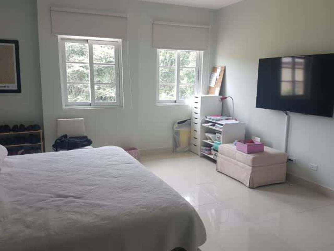 Bright bathroom with double sink and glass shower in house Clayton Panama