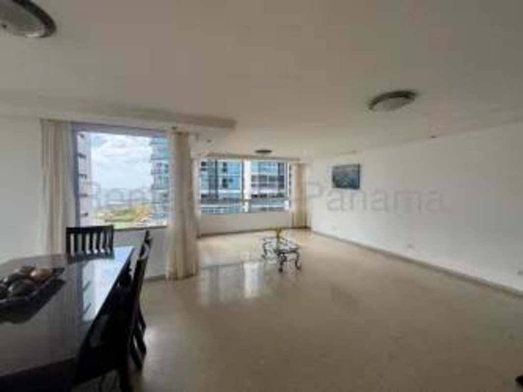 Dining and living area with large windows and balcony ocean views at PH Bahia Marbella Panama