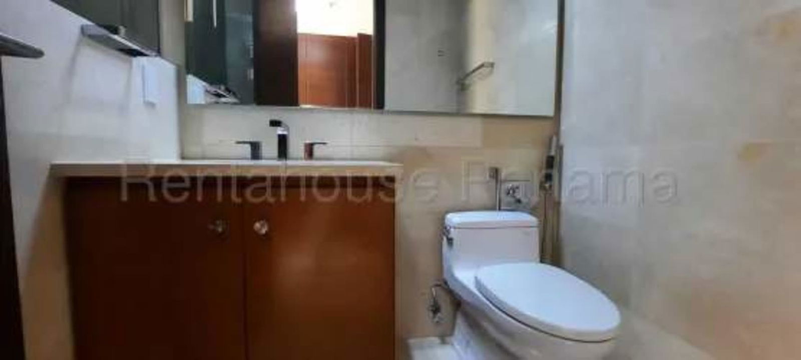 Contemporary bathroom with beige tile, wooden vanity, and mirror in Santa Maria Panama