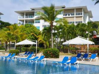 Oceanfront penthouse balcony with modern furniture Bijao Beach Residences Panama