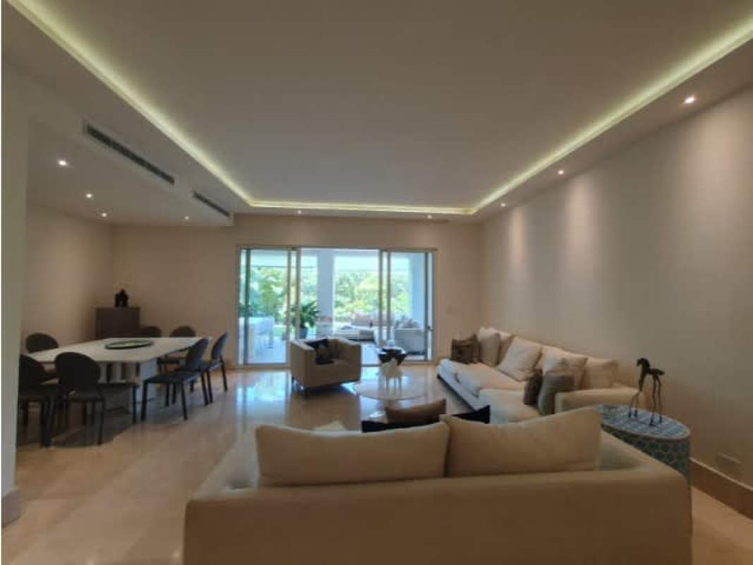 Spacious living room with sliding glass doors overlooking private garden at The Reserve Santa Maria Panama