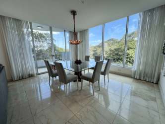 Bright dining room with marble floors and ocean views in Miramar Residences Veracruz Panama