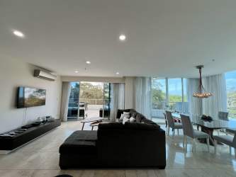 Modern open living room with panoramic windows beach condo rental Miramar Veracruz Panama