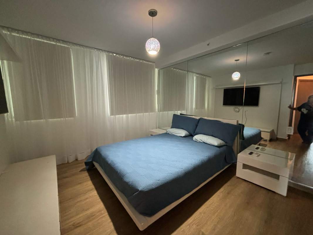 Bedroom with built-in wardrobe, sheer curtains, wood floor, minimalist style in PH Lumiere Panama