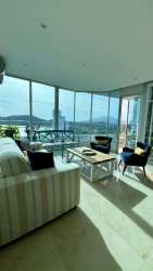 Bright master bedroom with ocean views and large windows at PH Casa Bonita Veracuz Panama