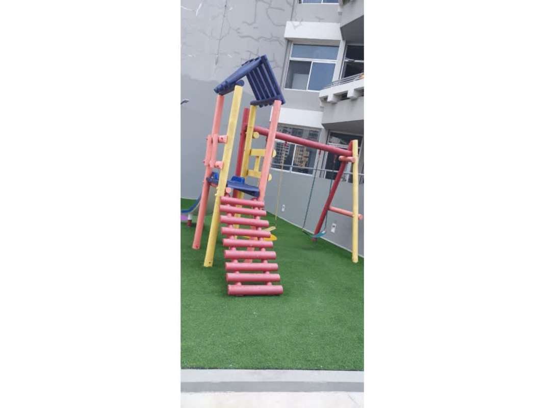 Swimming pool with lounge deck and skyline backdrop at PH Luxor Panama City