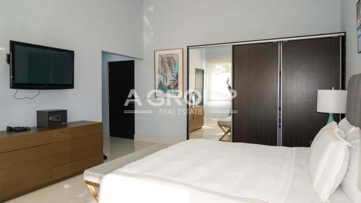 Bedroom furnished with large windows facing garden pool luxury villa Panama