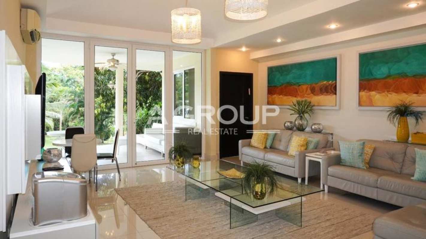 Modern living room with large glass doors overlooking tropical gardens Santa Clara Panama