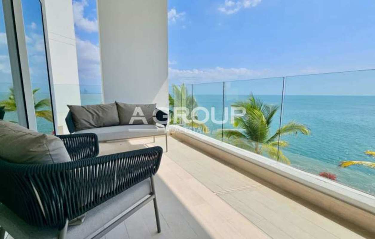 Open-concept modern living room with floor-to-ceiling ocean view windows at Ocean Reef Islands Panama