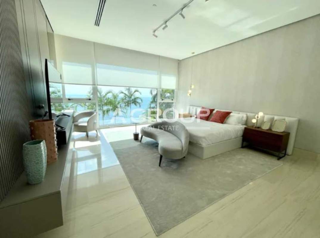 Luxury secondary bedroom with floor-to-ceiling windows ocean views at Ocean Reef Panama