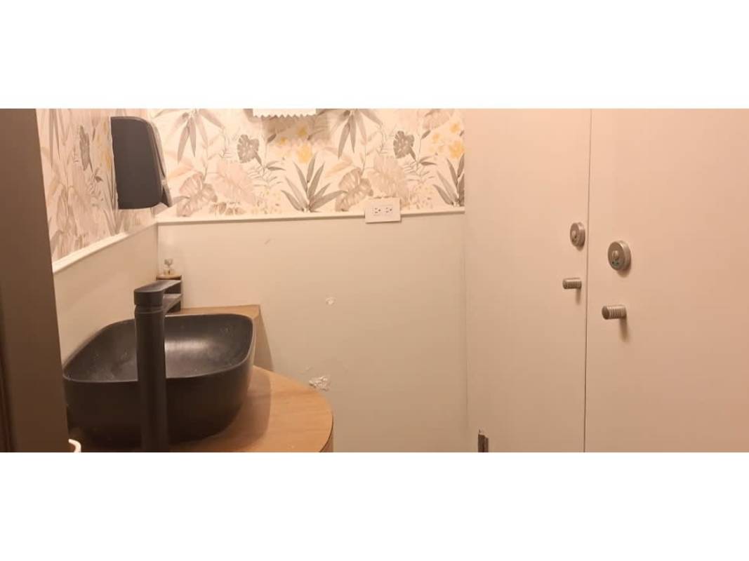 Contemporary bathroom with vessel sink, decorative wallpaper and modern faucet rental space San Francisco Panama
