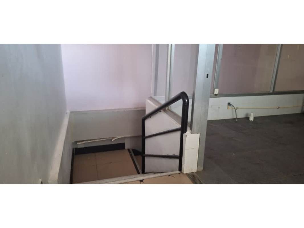 Indoor staircase to basement area metal handrail tiled floors commercial plaza panama