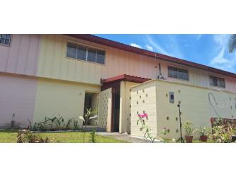 Bright living room with staircase and large windows in Villas de Howard house Panama Pacifico