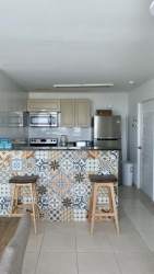 Open kitchen with appliances, granite counters in PH Coronado Bay beach condo Panama