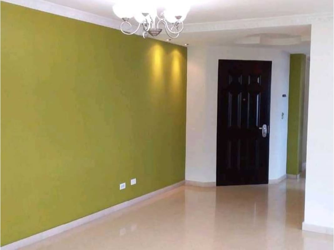 Living room with green accent wall, tile floor, chandelier Hato Pintado Panama