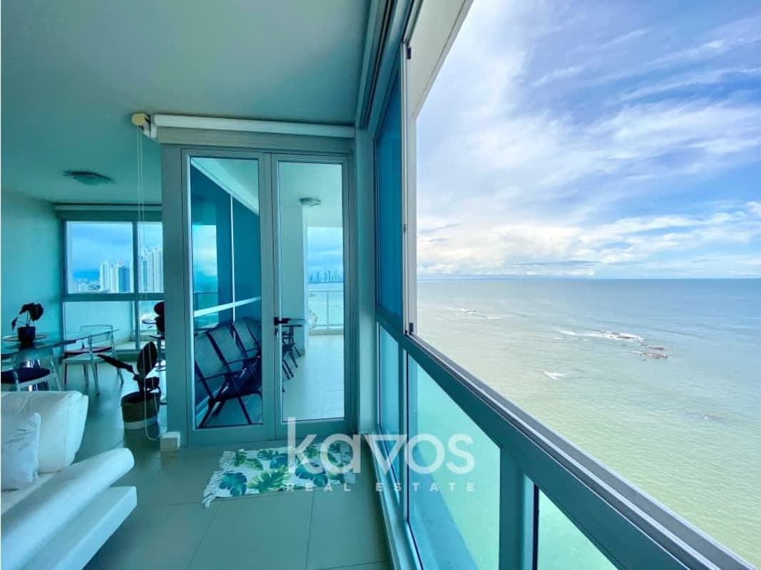 Modern living room with ocean view through large windows at PH Oceanaire Punta Pacífica Panama