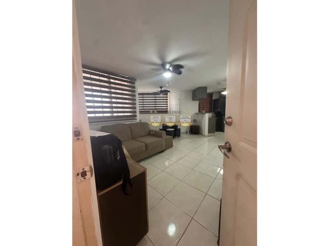 Kitchen with granite style countertops, gas stove, refrigerator and cabinets at Llano Bonito apartment Panama