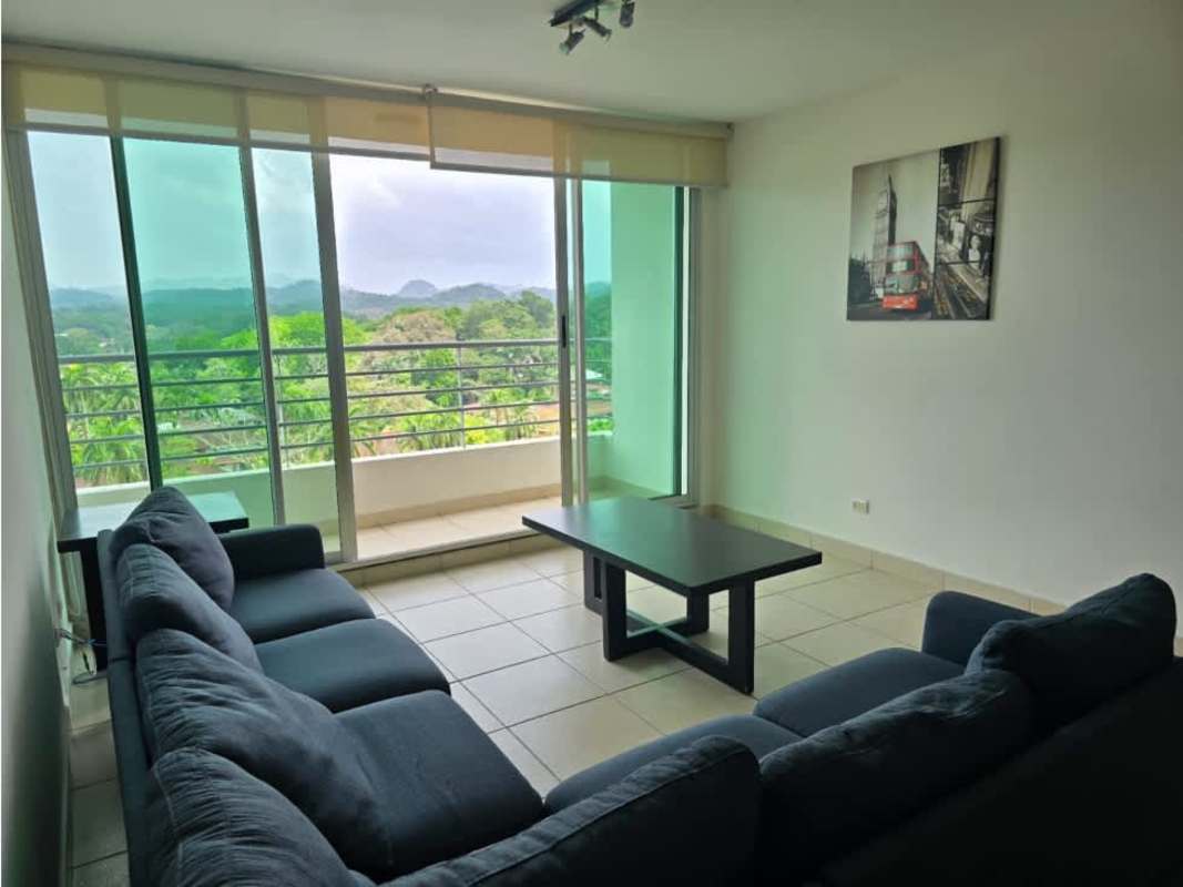 Bright living room with large windows and balcony access overlooking green landscape in Clayton Park I Panama