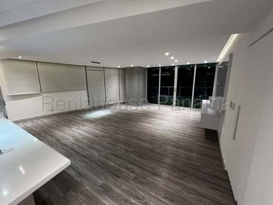 Expansive living and dining room with floor-to-ceiling windows ocean view PH Joy Tower San Francisco Panama