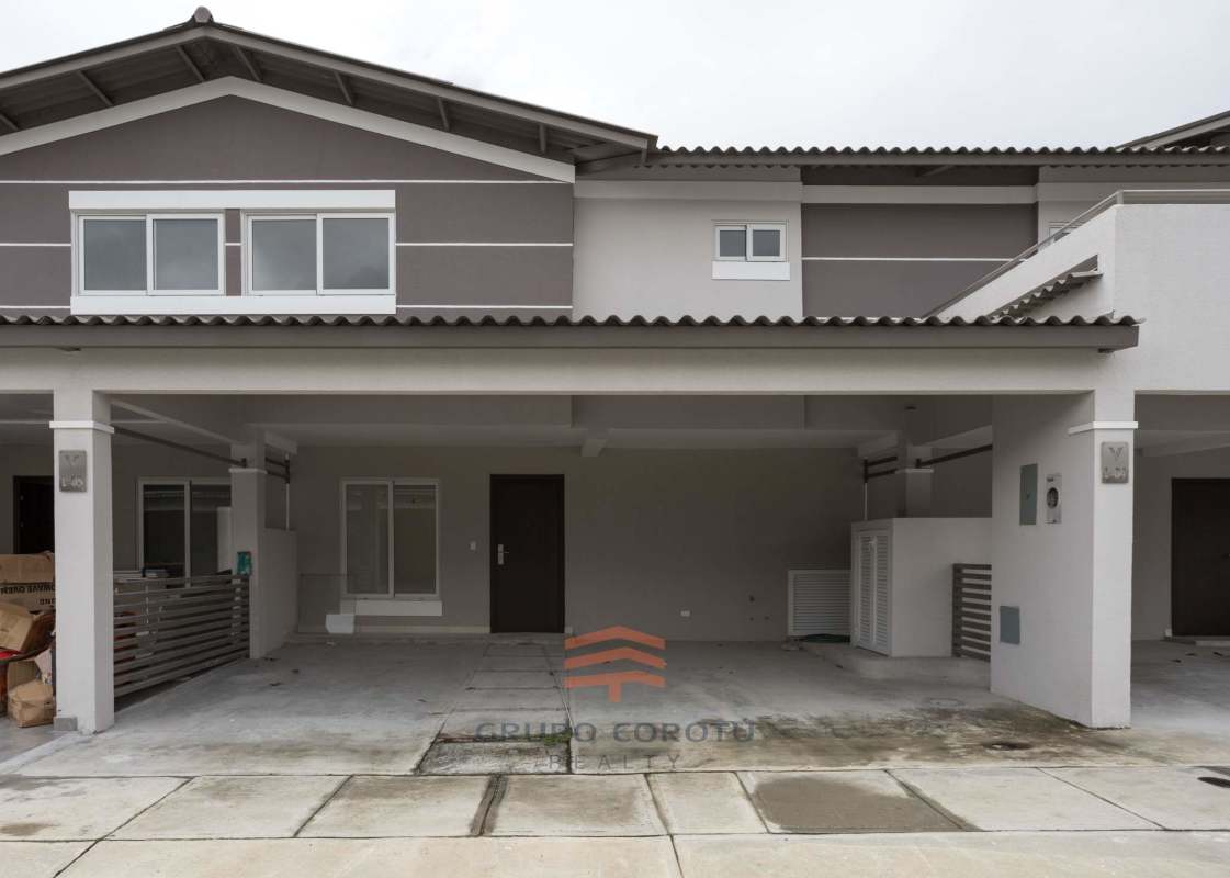 Bright modern living room with porcelain tile floors and large window in Costa Sur duplex home