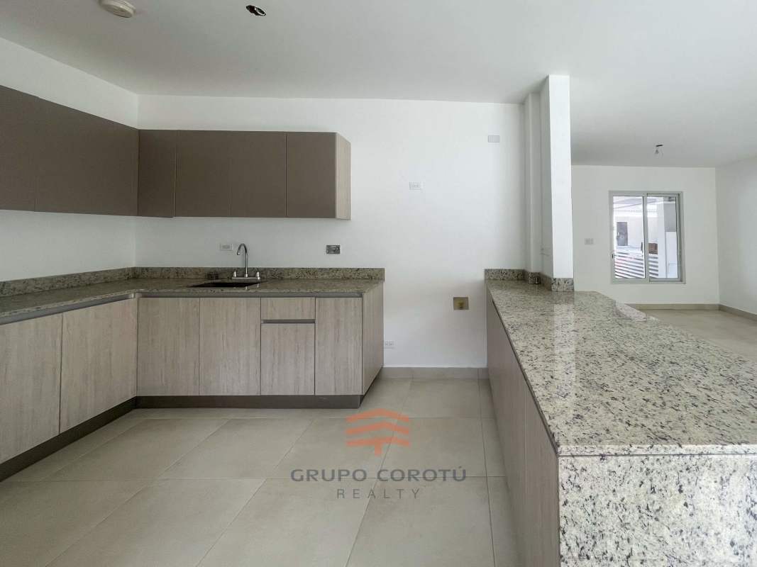 Spacious kitchen area with granite countertops ready for installation in Costa Sur duplex