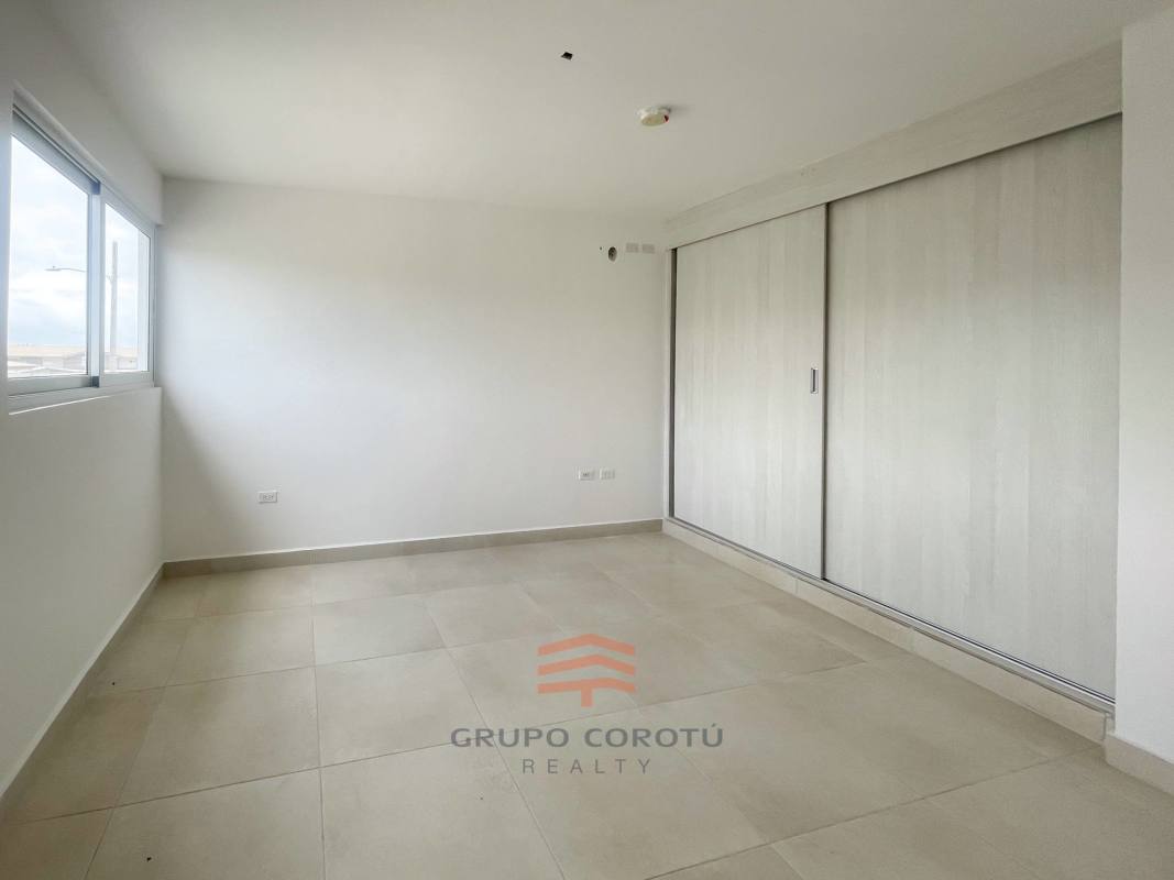 Bathroom with glass-enclosed shower, granite counters, porcelain tiles in Costa Sur duplex