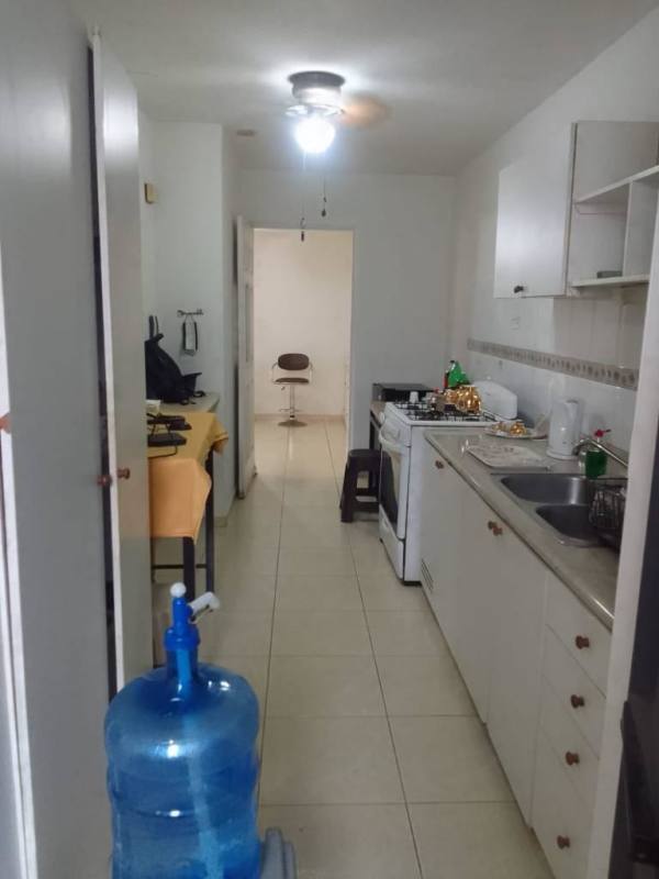 Functional galley kitchen with tile floors, stove, and dining space, PH Marina Plaza Panama