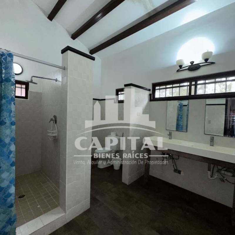 Bathroom with double sink vanity, walk-in shower, exposed beams and natural light in boutique hotel Cerro Azul
