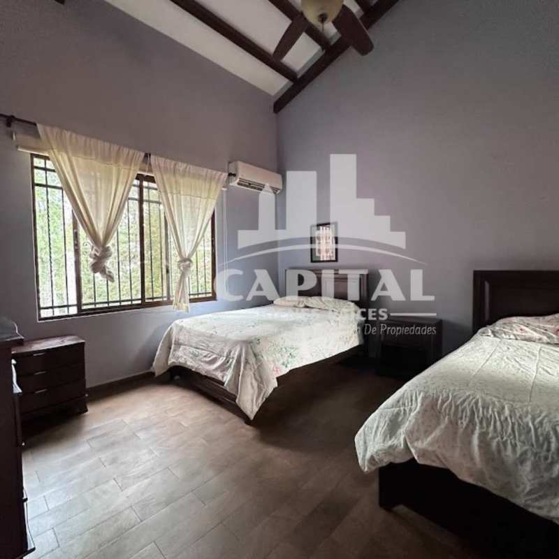 Aerial view of rustic boutique hotel with rooftops, lush forest, gardens and outdoor event areas in Cerro Azul Panama