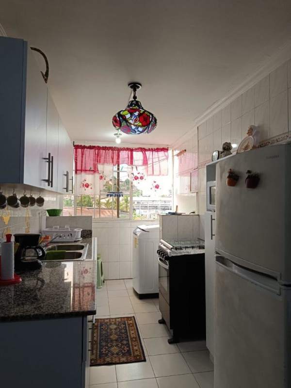 Kitchen in PH Mystic Park with granite counters and colorful hanging pendant light Panama City