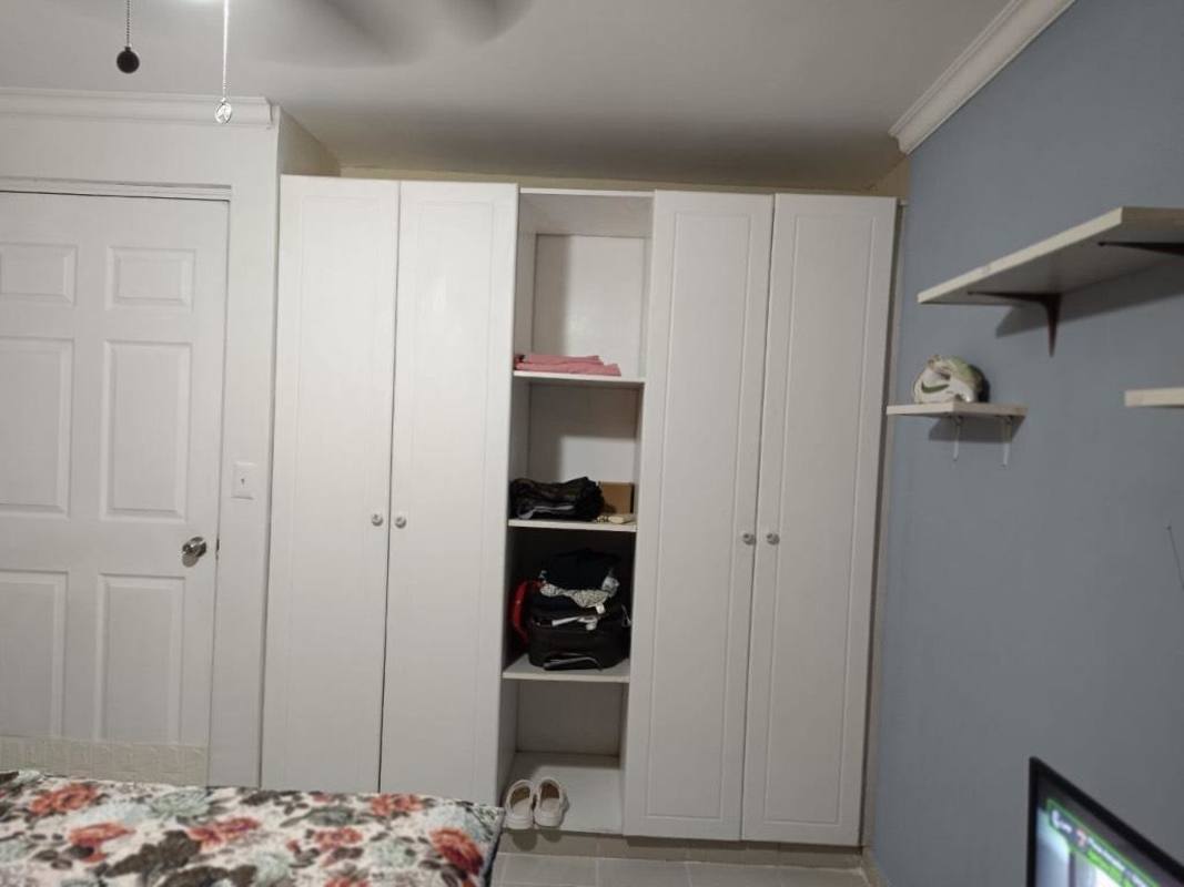 Apartment kitchen featuring granite countertop, window with red curtains at PH Mystic Park Panama City