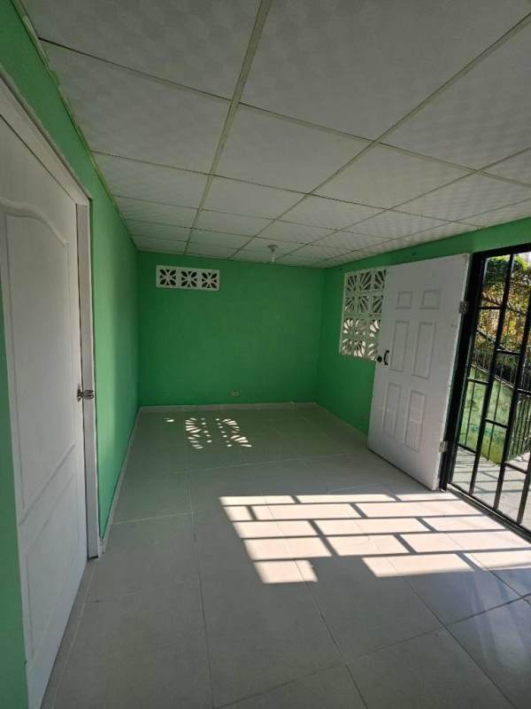 Exterior entry with metal security bars two-story building in Samaria affordable Panama rentals