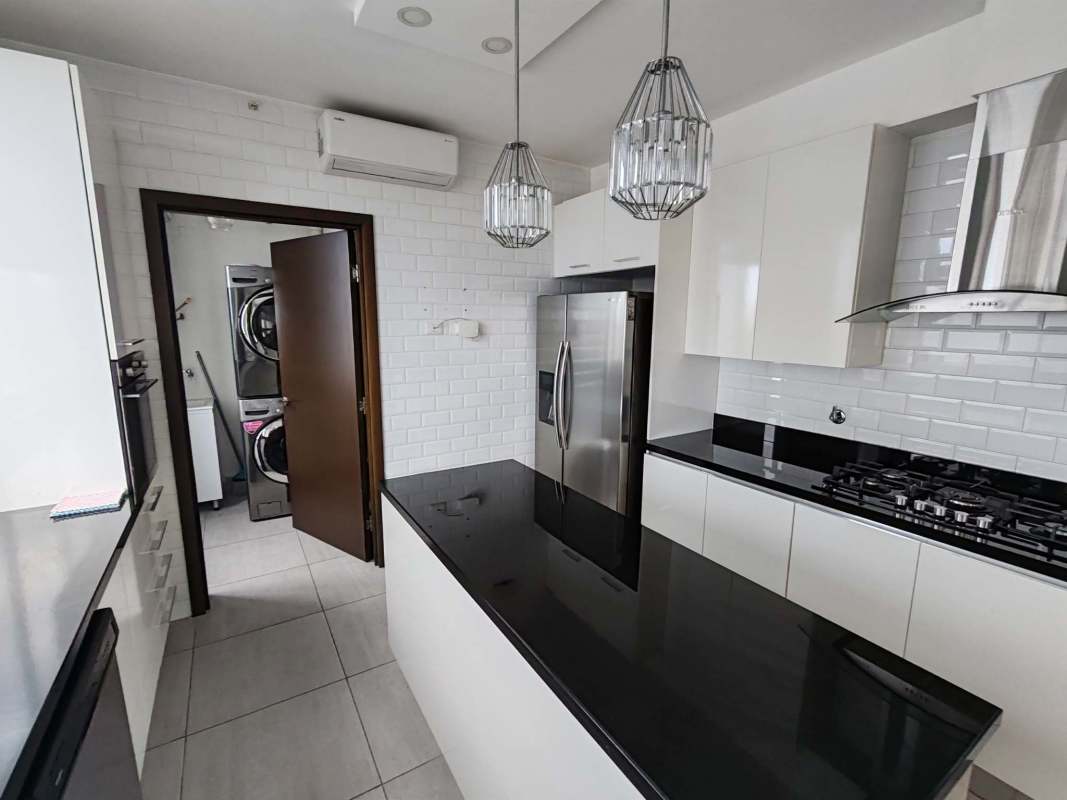 Modern bathroom with granite top vanity and glass enclosed shower Panama City apartment