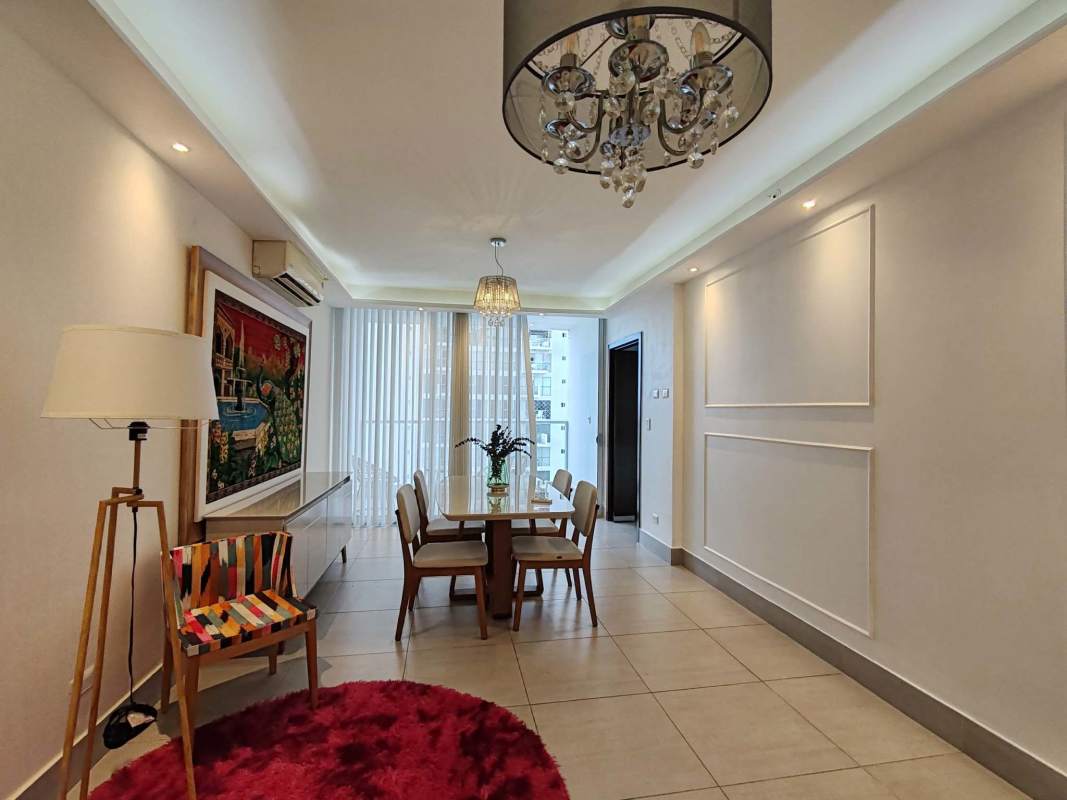 Bright dining space with windows and modern chandelier in Jade Tower apartment for sale