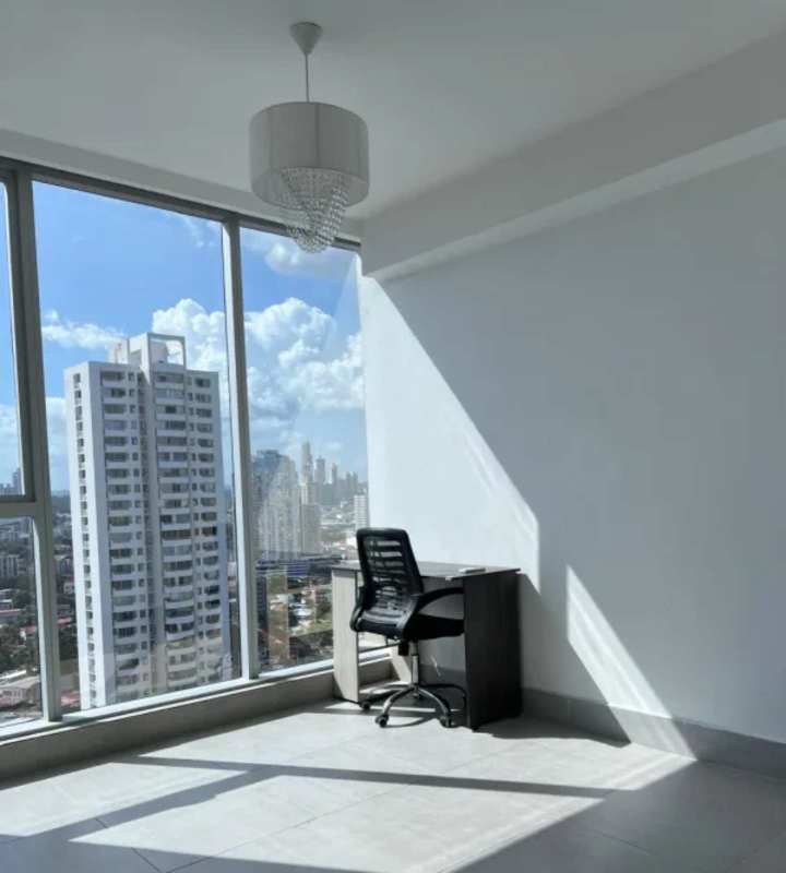 Contemporary kitchen with granite counters, overhead cabinets and large window in Panama City apartment