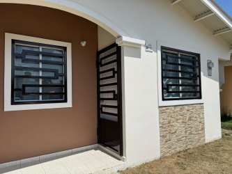 Bedroom with white built-in closet tiled floor window bars at Bosque Dorado La Chorrera Panama