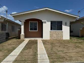Single-story house front porch stone facade fenced Bosque Dorado La Chorrera Panama