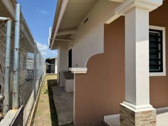 Side view white house porch fence window in Bosque Dorado La Chorrera Panama
