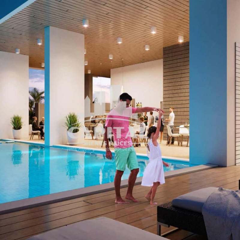 Indoor pool with wood ceiling, lounge seating in PH The Balcony Panama