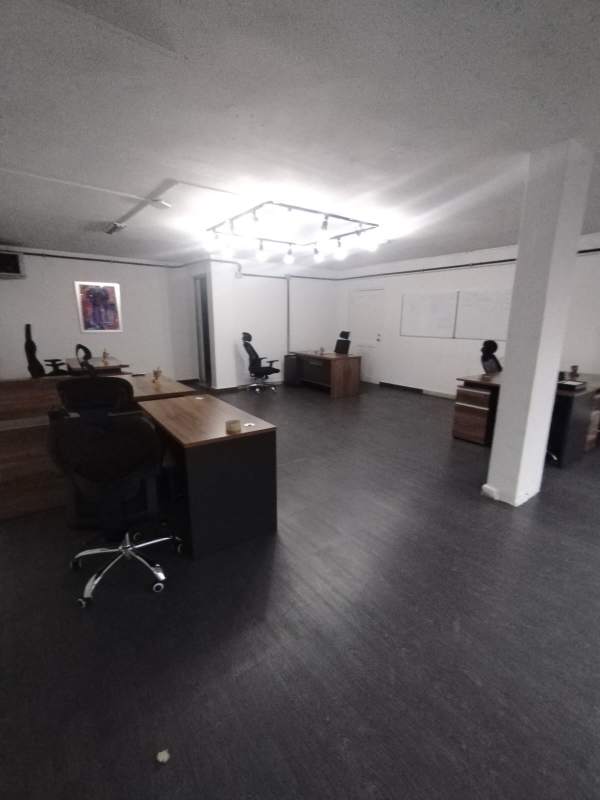 Galley kitchen with beige tiles, dark counters, window and cabinets in PH Comercial El Carmen Panama City