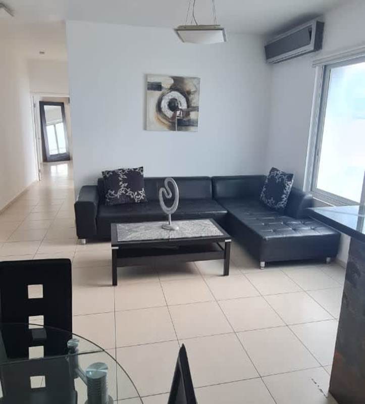 Bedroom with tile floors, large window, sea view in PH Miramar Avenida Balboa Panama City