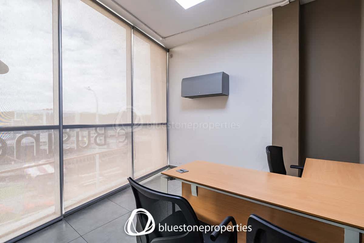 Meeting room with glass walls and conference table in commercial office Panama Viejo Business Center