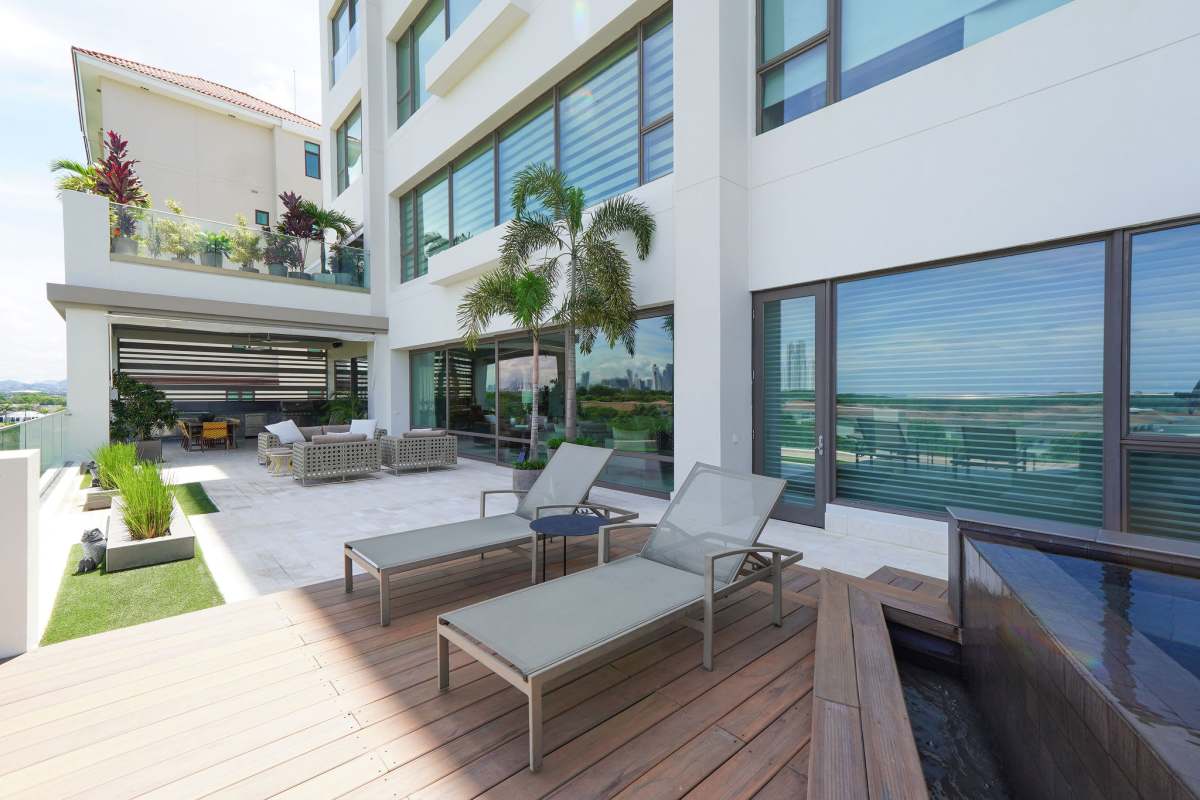 Spacious modern dining room with chandelier, golf views luxury condo in Santa María Panama