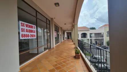 Covered open-air arcade walkway with storefronts at The Village commercial plaza Coronado Panama