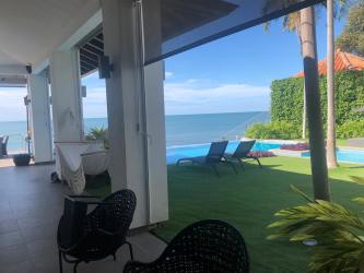 Infinity pool deck with lounge chairs, Pacific Ocean view in luxury beachfront home Coronado Panama