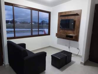 Living room entry with floor-to-ceiling windows and armchairs Senderos Santa Monica Panama