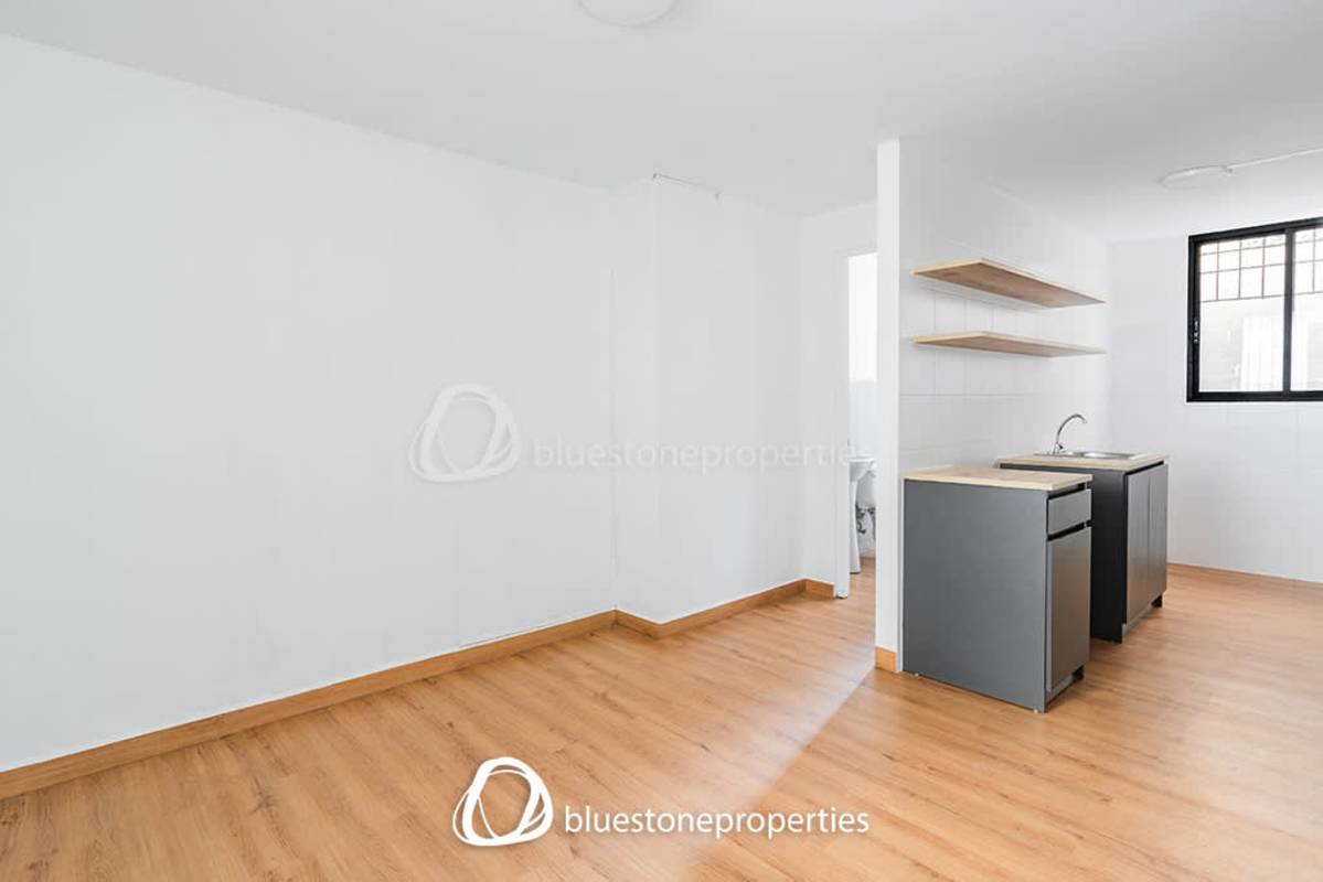 Modern minimalist kitchen with open shelving and tiled walls in La Exposición Panama City