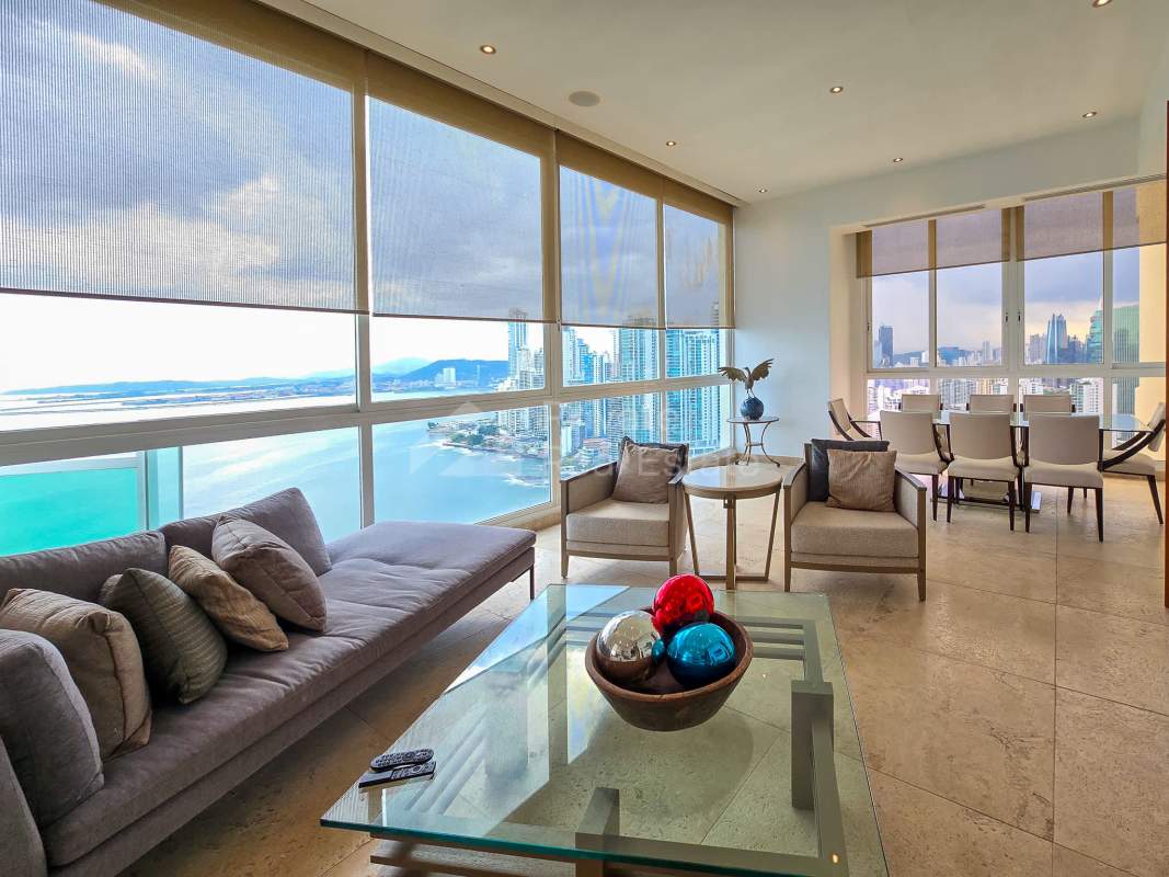 Large living room with panoramic ocean views, floor-to-ceiling windows in Punta Pacífica luxury condo