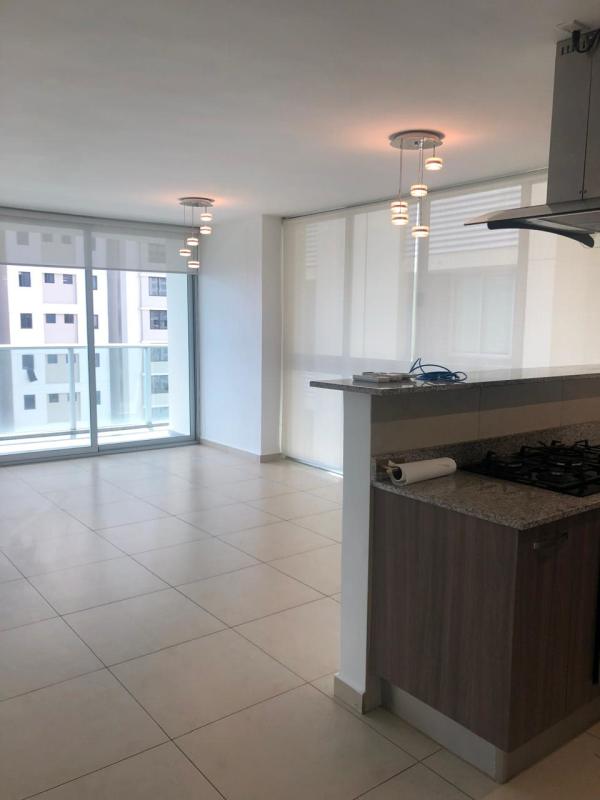 Bright living room with sliding doors leading to balcony ocean view at PH Lumiere Costa del Este Panama