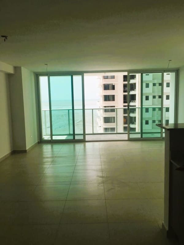 Modern open kitchen with granite counters, appliances and large windows in PH Lumiere Costa del Este Panama